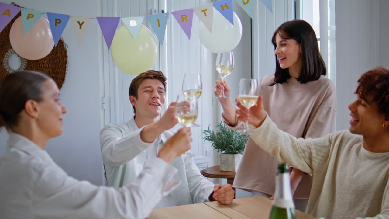 Carefree teenagers toasting champagne at birthday party closeup. Festive people
