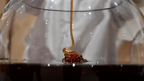 4k close-up shot: thick dark uae's acacia honey dripping, organic honey dipper in glasses bowl, healthy organic thick honey, healthy food concept