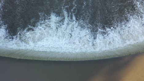 water overflowing dam from above