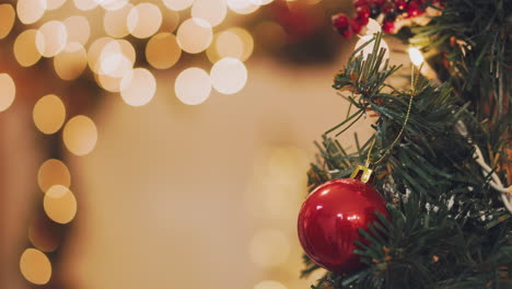 Hand-of-woman-decorating-Christmas-tree-with-Christmas-glow-lights.