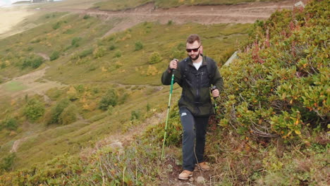 man hiking in mountains during autumn