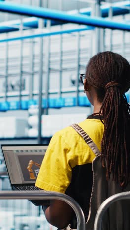 vertical video manager supervising photovoltaic smart factory workers using cad software
