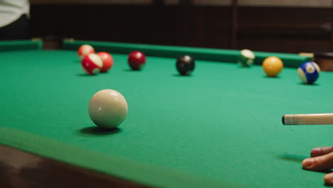 playing american billiard poule close-up. colorful balls on green billiards table .billiard balls with numbers on a pool table. billiards team sport.high quality 4k footage