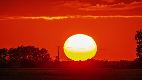 massive red sunset over rural landscape of latvia, time lapse view