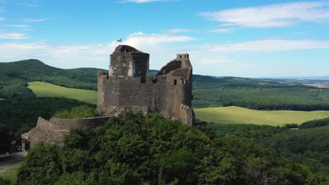 drone footage about ruins of an old castle from the middle ages at holloko, hungary drone circles left