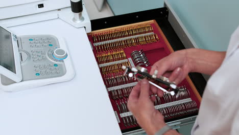 ophthalmologist opening a drawer with lenses