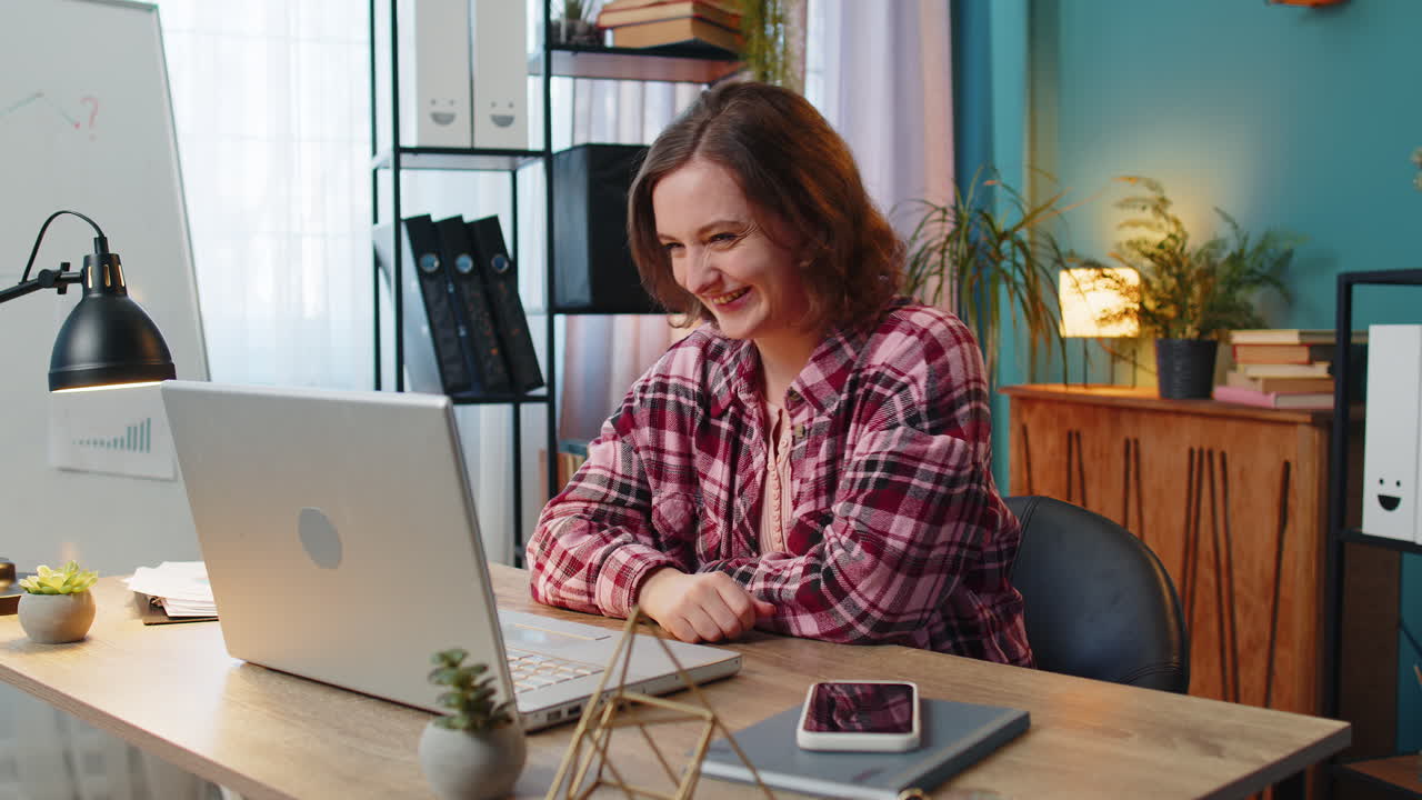 Business woman working on laptop computer home office desk talk on online communication video call