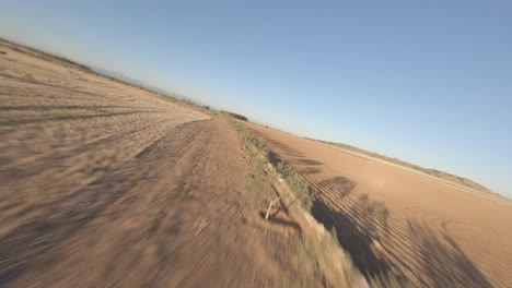 fpv racing drone in spanish countyside fields in hot summer season