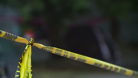 homeless tents surround by police tape rack focus