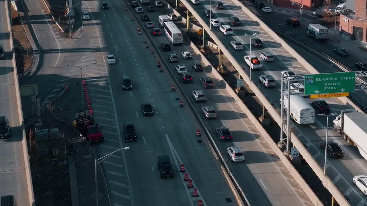 Traffic flows along a busy highway in New York during daytime hours