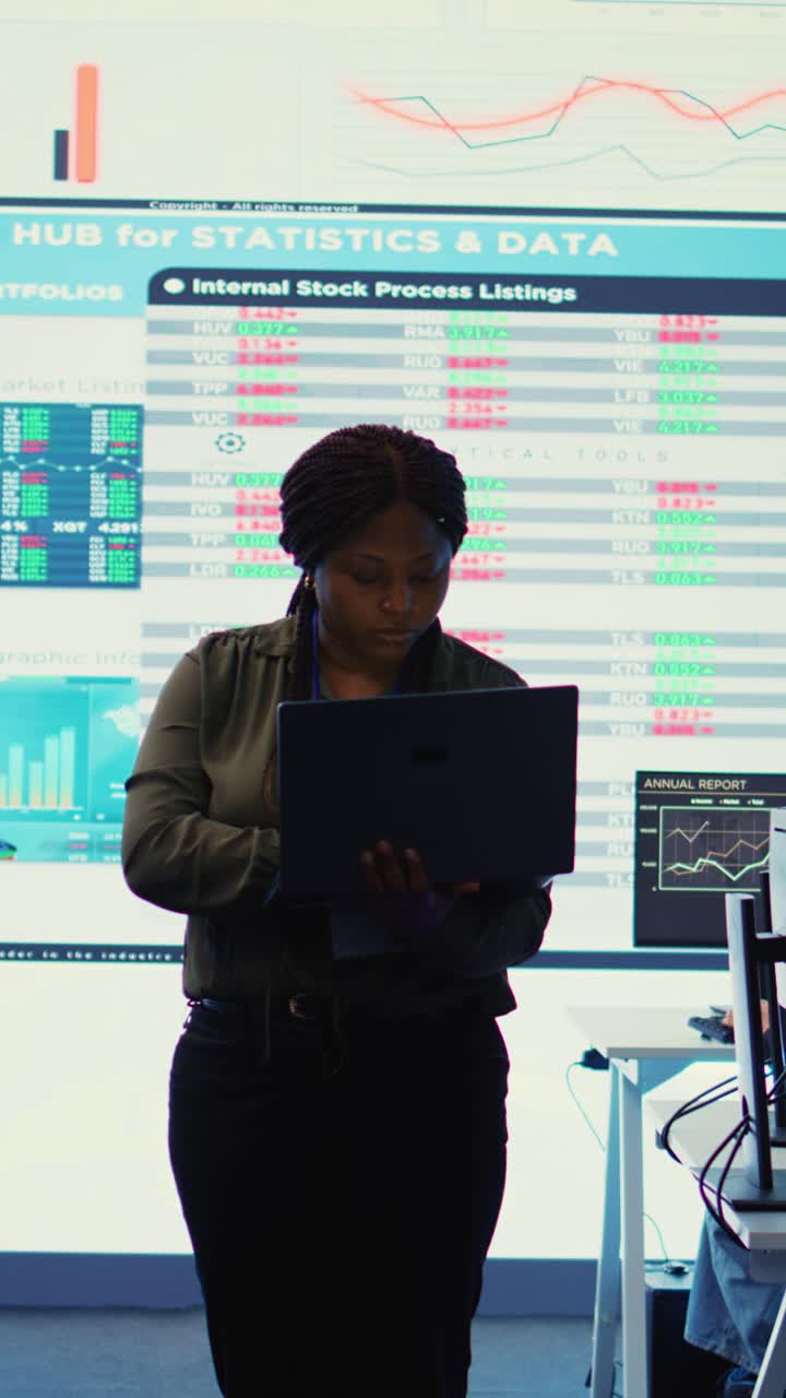 African American Businesswoman Analyzing Data on Laptop in Modern Office