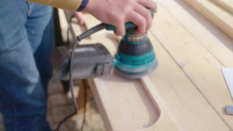 close up of the sanding of the wood with a grinding machine