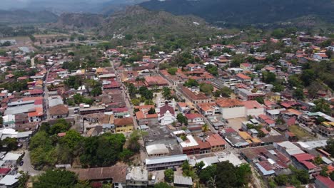 Aerial-descends-to-Catholic-church-and-central-park-plaza-in-Copan-HND