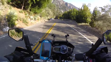 rider driving motorcycle on forest road on mount baldy, california, usa. pov