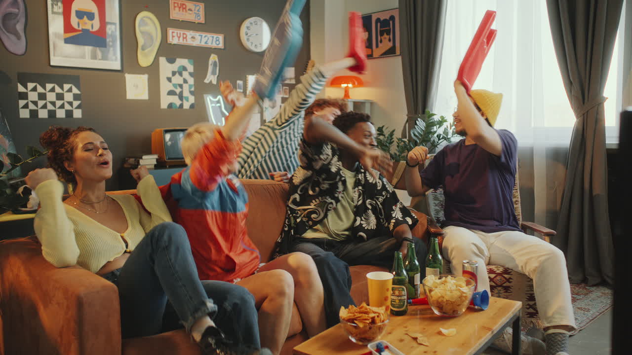Group of Friends Watching Sports Game and Celebrating in Modern Living Room