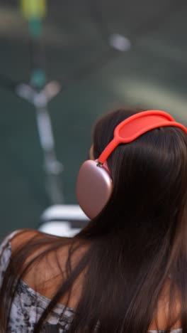 woman with red headband and headphones