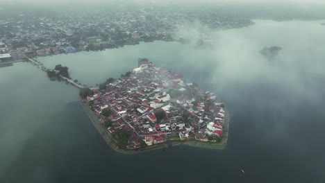 El-Petén-Flores-Island-In-Guatemala-with-low-clouds-sunrise,-aerial