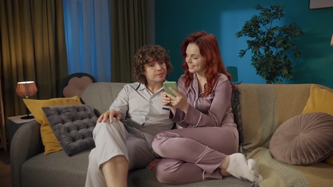 Couple Relaxing and Chatting on a Sofa