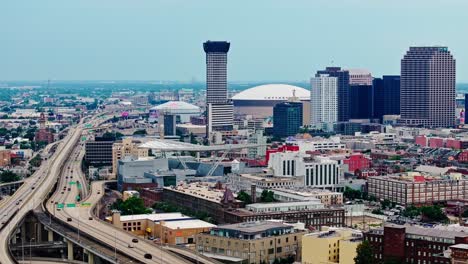 skyscraper of plaza tower with caesars superdome in the background in new orleans, louisiana, united states. aerial wide shot