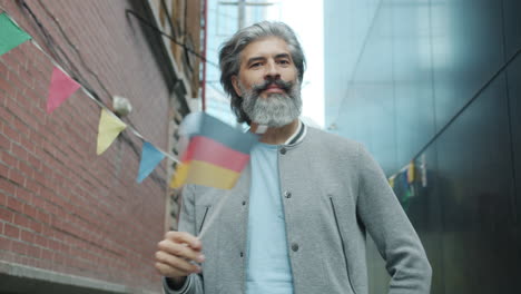 man with german flag in city street