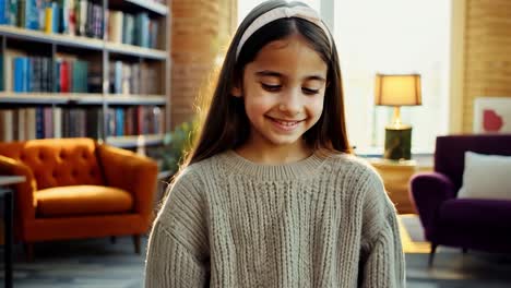 a young girl smiles happily in a library setting