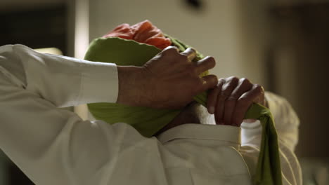 Close-Up-Studio-Shot-Of-Senior-Sikh-Man-With-Beard-Tying-Fabric-For-Turban-Viewed-From-Behind-Shot-In-Real-Time-1