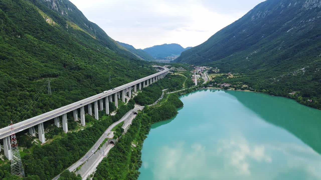 Establishing shot, turquoise lake and viaduct in Treviso, Italy, at golden hour