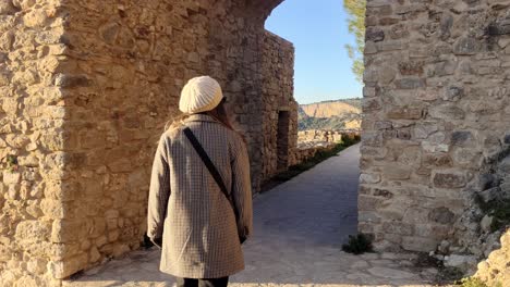 tracking shot of a woman walking and exploring the sites at ronda, spain