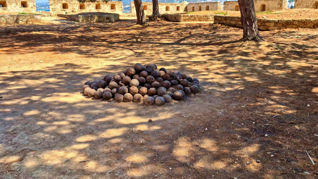 Ancient cannonballs stacked at the Fortezza of Rethymno in Crete, Greece - isolated push in