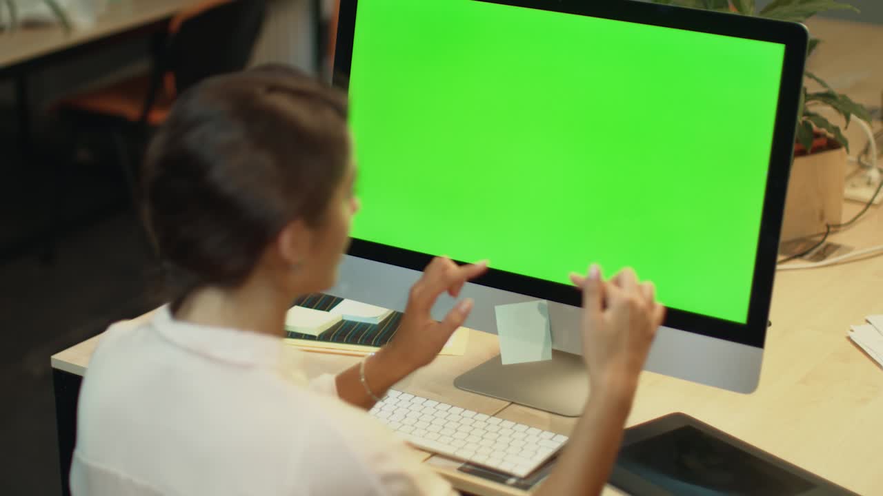 mujer de negocios llama video en línea en la computadora con pantalla verde en la oficina