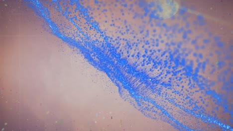 animation of blue glitter moving over beige background