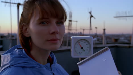 woman observing on a rooftop at twilight