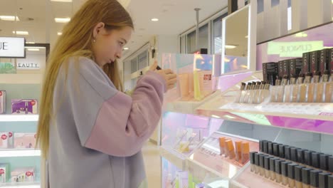 young red headed girl taking time to browse the beauty products for sale