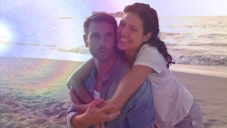 animación de luz moviéndose sobre una feliz pareja caucásica en la playa