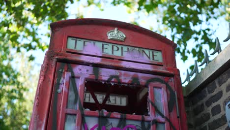 Clip-of-the-vandalized-telephone-booth-with-broken-glass-and-graffiti-paint