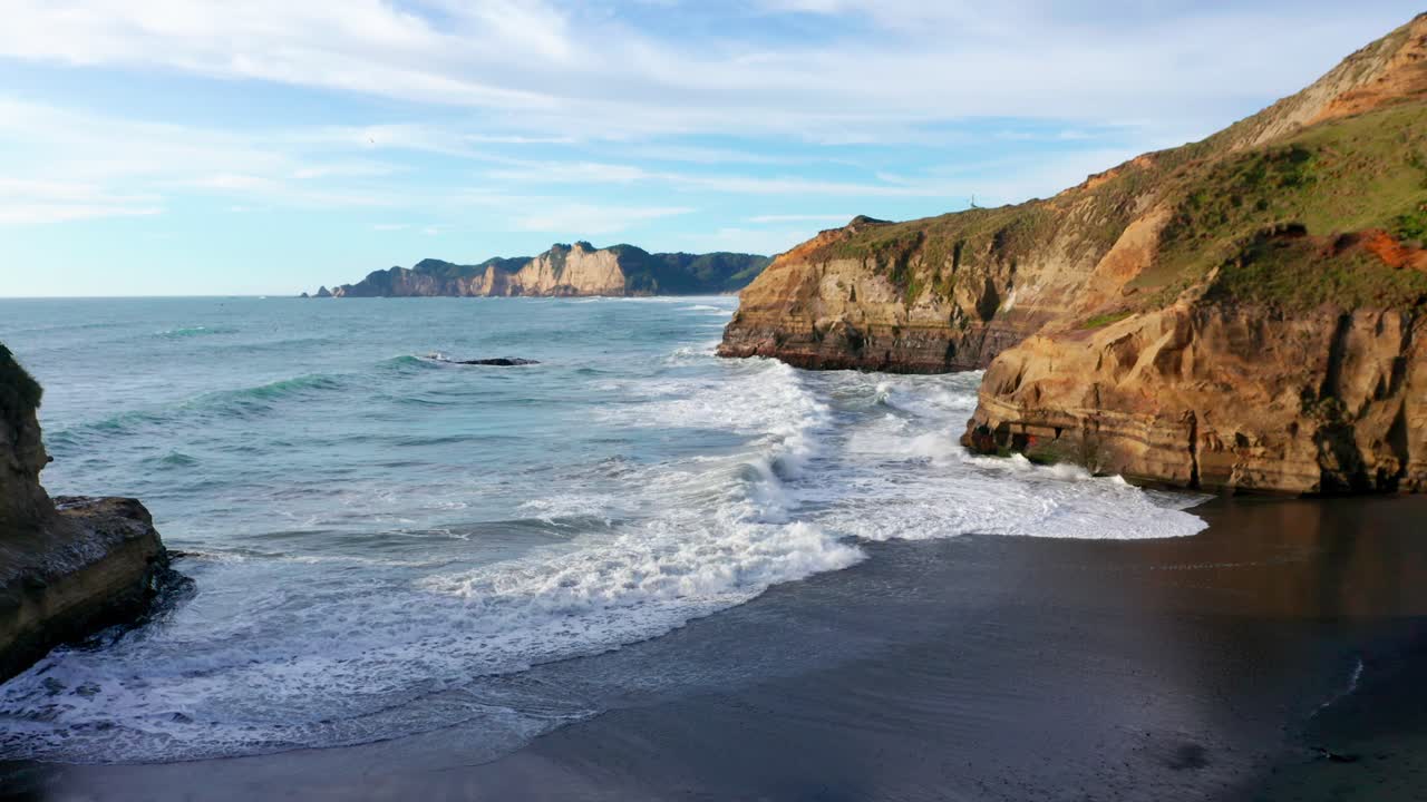 View Of Pacific Ocean Waves Breaking Onto Small Beach In Chiloe