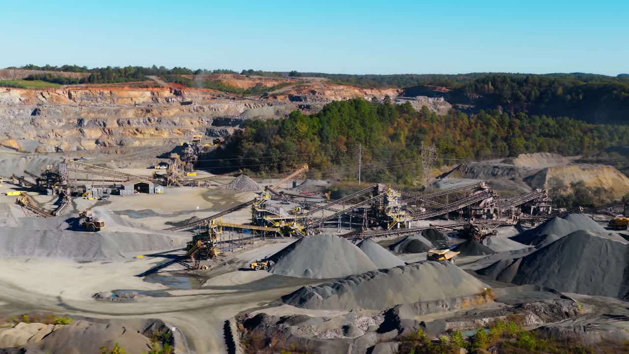 Aerial wide overview of quarry operations with gravel piles and conveyor systems in Arkansas USA