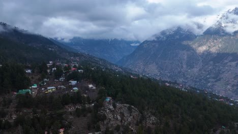 mountain village in a valley under cloudy sky