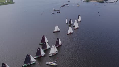 Drone-view-of-classic-sailing-boats-at-Tjeukemeer-Friesland,-aerial