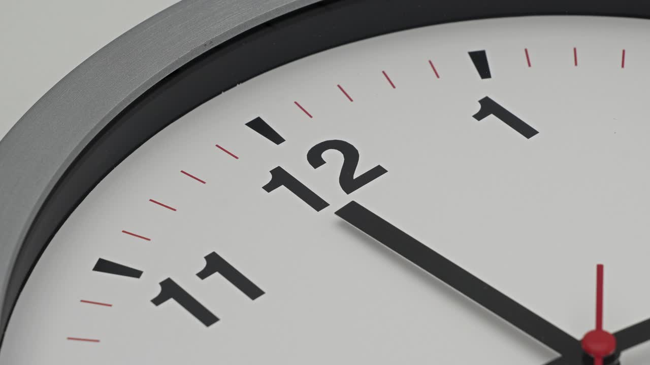 Time-lapse gray clock with black arrows shows motion the time speed up from 11.00 to 12.00, How time flies concept.
