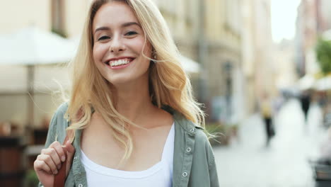 caucasian young blonde woman walking down the street