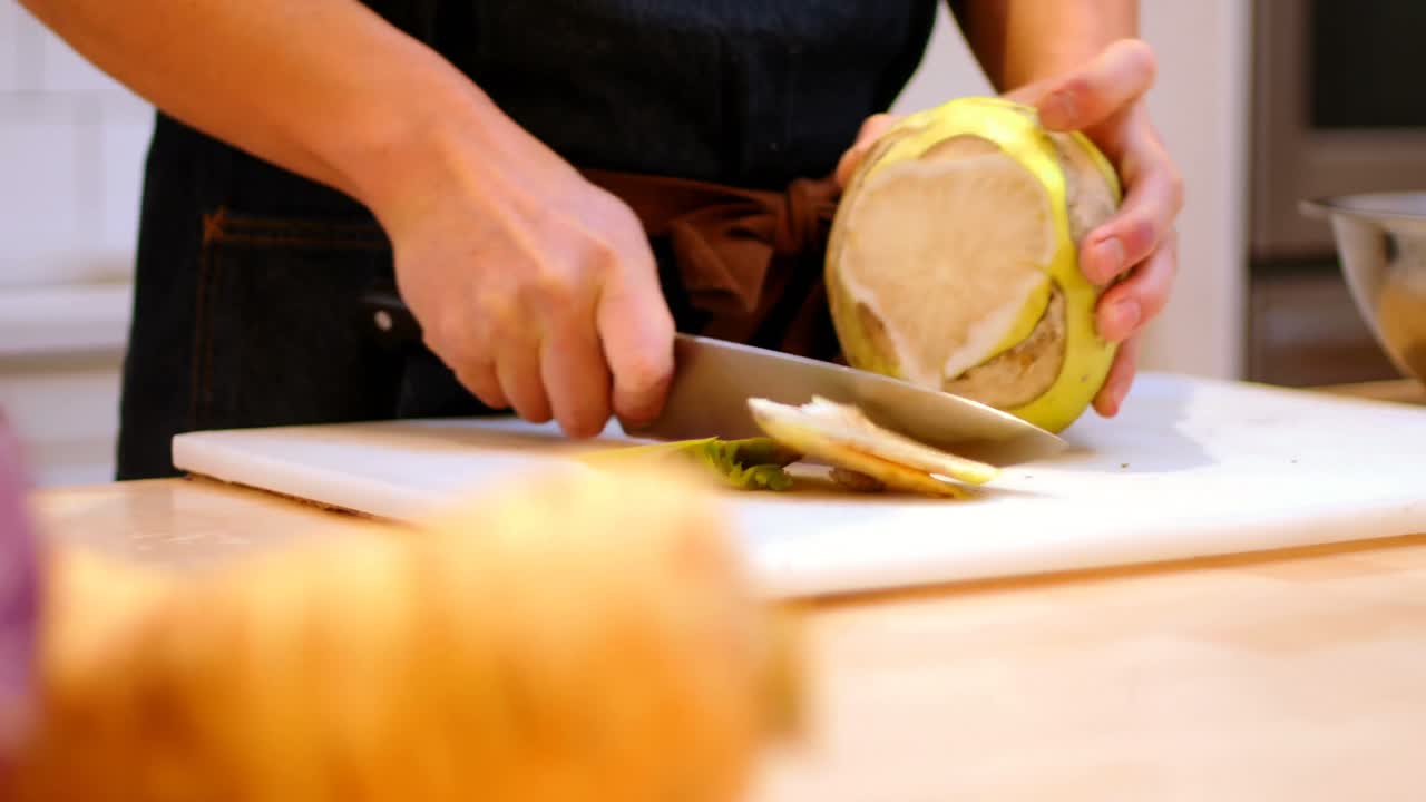 Chef chopping the outer skin of kohlrabi vegetable