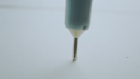 Closeup of a pen tip on white paper