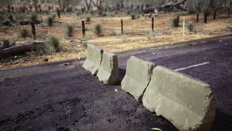 road barrier shows signs of weathering in an outback landscape during daytime