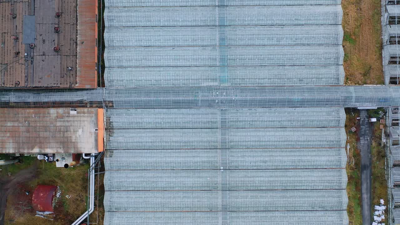 Aerial or flying over the greenhouses. Engineering structures near glass greenhouses