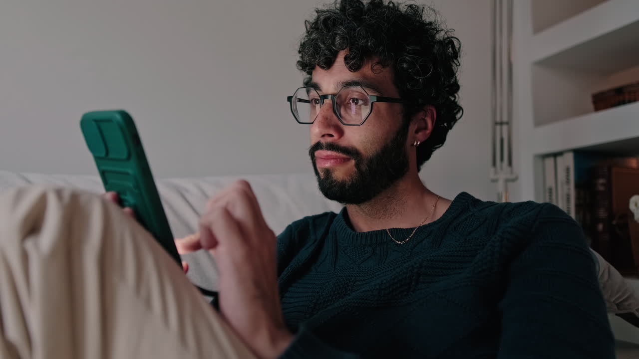 Young man or gay at Home Using Smartphone