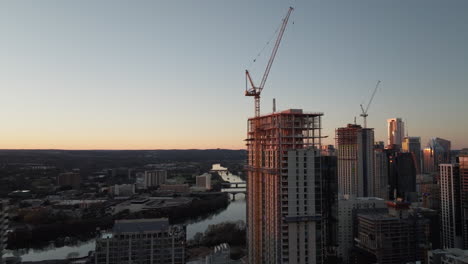 beautiful aerial of downtown austin texas buildings with lady bird lake river at sunset