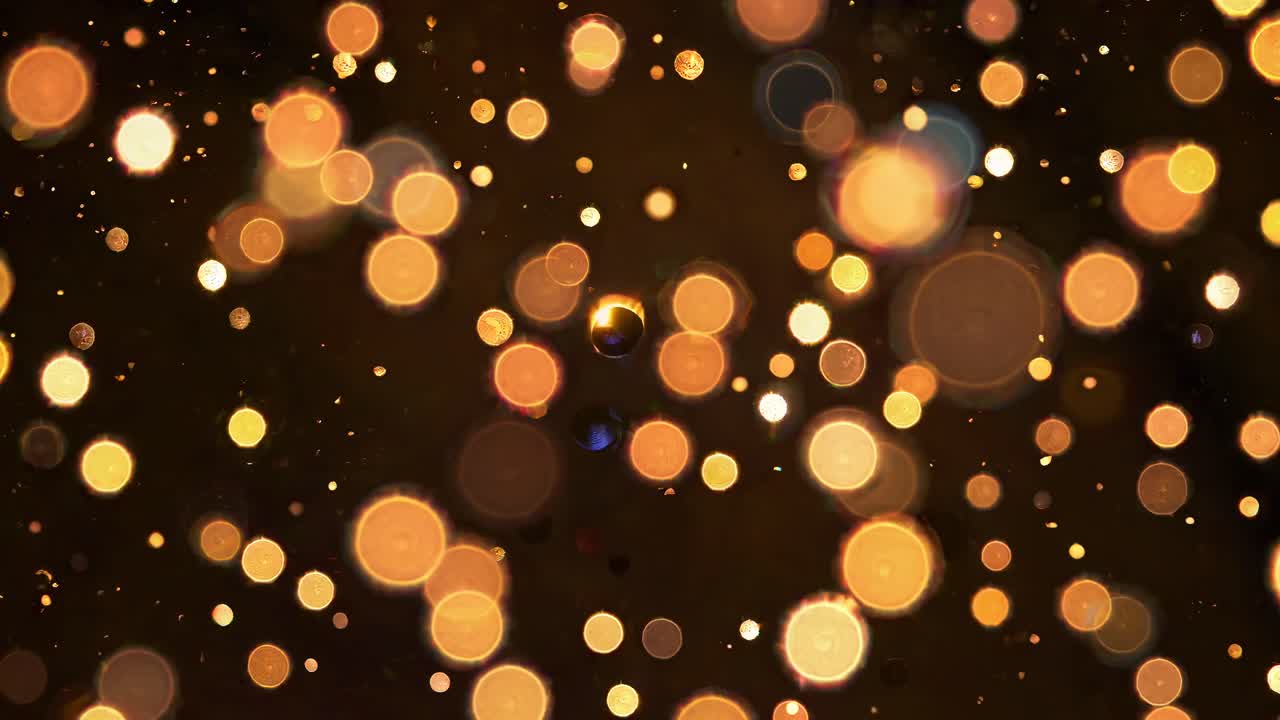 The video features a dreamy, abstract concept with glowing bokeh lights floating against a dark