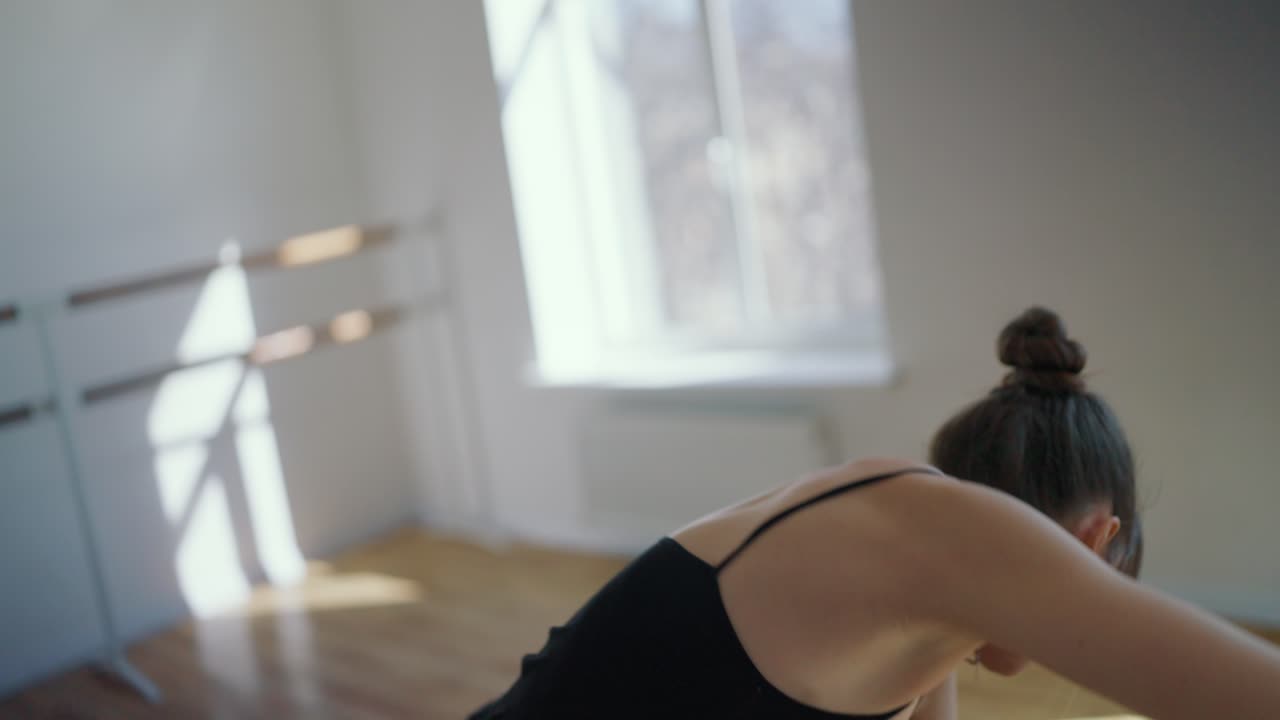 A woman is dancing in a studio