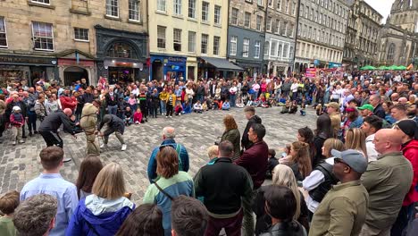 crowd watching performers in edinburgh, scotland